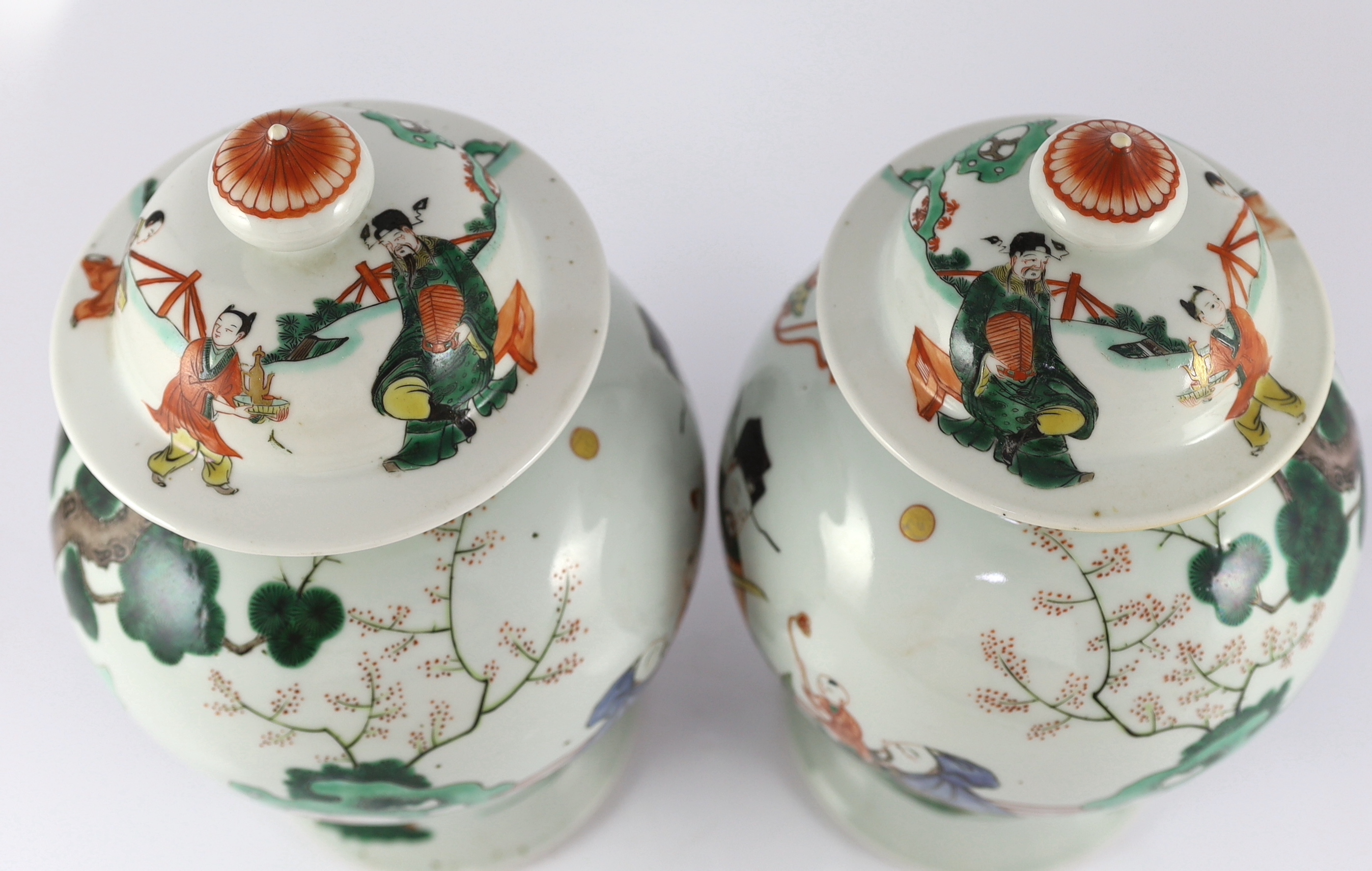 A pair of Chinese famille verte ‘Sanxing’ vases and covers, 19th century, some cracks